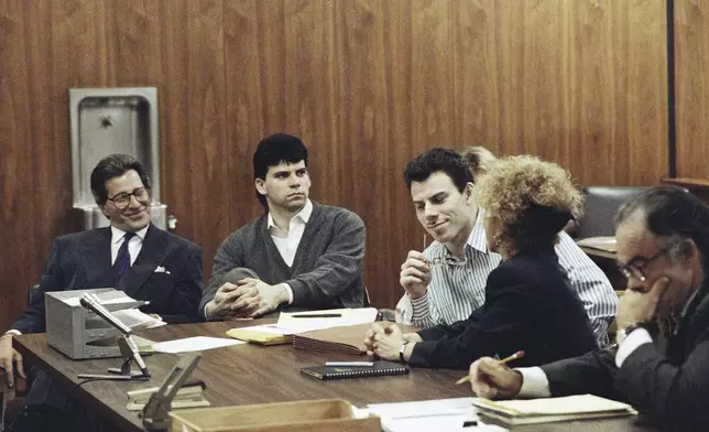 FILE - Erik Menendez, center, listens to his attorney Leslie Abramson, as his brother Lyle looks on in a Beverly Hills, California, May 17, 1991. (AP Photo/Julie Markes, File)