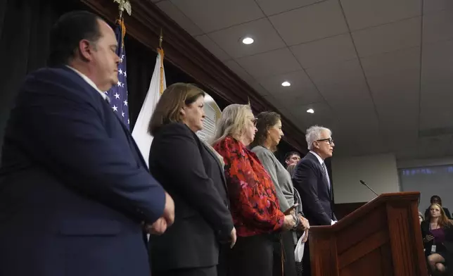 Los Angeles County District Attorney George Gascon, right, flanked by Menendez family members, speaks during a news conference at the Hall of Justice, Thursday, Oct. 24, 2024, in Los Angeles. (AP Photo/Eric Thayer)