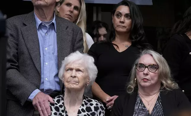 Kitty Menendez' sister, Joan Andersen VanderMolen, bottom left, and niece Karen VanderMolen, right, sit together during a press conference to announce developments on the case of brothers Erik and Lyle Menendez, Wednesday, Oct. 16, 2024, in Los Angeles. (AP Photo/Damian Dovarganes)