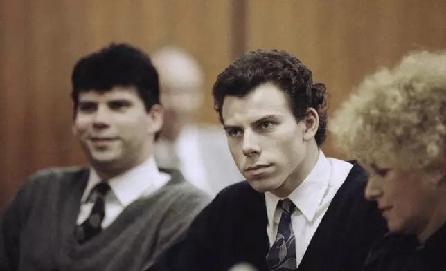 FILE - Lyle, left, and Erik Menendez sit with defense attorney Leslie Abramson, right, in Beverly Hills Municipal Court during a hearing, Nov. 26, 1990. (AP Photo/Nick Ut, File)