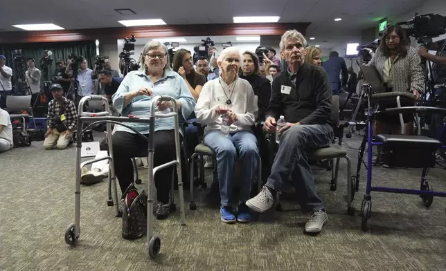 Diane Hernandez niece of Kitty Menendez is joined by Arnold VanderMolen, Nephew of Kitty Menendez, right, and Kitty Menendez's sister, Joan Andersen VanderMolen, center sit at a news conference being held by Los Angeles County District Attorney George Gascon on Thursday, Oct. 24, 2024, in Los Angeles. (AP Photo/Eric Thayer)