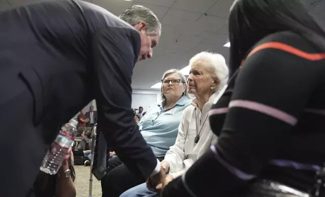 Family attorney Bryan Freedman, left greets Kitty Menendez's sister, Joan Andersen VanderMolen, center as Diane Hernandez niece of Kitty Menendez, left, looks on prior to a news conference being held by Los Angeles County District Attorney George Gascon at the Hall of Justice on Thursday, Oct. 24, 2024, in Los Angeles. (AP Photo/Eric Thayer)