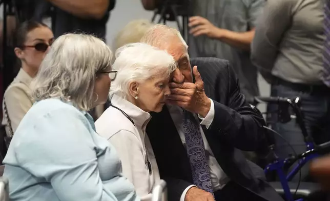 Kitty Menendez's sister, Joan Andersen VanderMolen, center, listens to Defense Attorney Mark Geragos, right, as Diane Hernandez niece of Kitty Menendez, left, looks on prior to a news conference being held by Los Angeles County District Attorney George Gascon at the Hall of Justice on Thursday, Oct. 24, 2024, in Los Angeles (AP Photo/Damian Dovarganes)