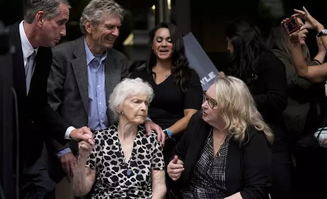 Kitty Menendez' sister, Joan Andersen VanderMolen, bottom left, and niece Karen VanderMolen, right, sit together during a press conference to announce developments on the case of brothers Erik and Lyle Menendez, Wednesday, Oct. 16, 2024, in Los Angeles. (AP Photo/Damian Dovarganes)