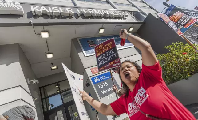 Mental health workers strike outside a Kaiser Permanente facility in Los Angeles Monday, Oct. 21, 2024. (AP Photo/Damian Dovarganes)