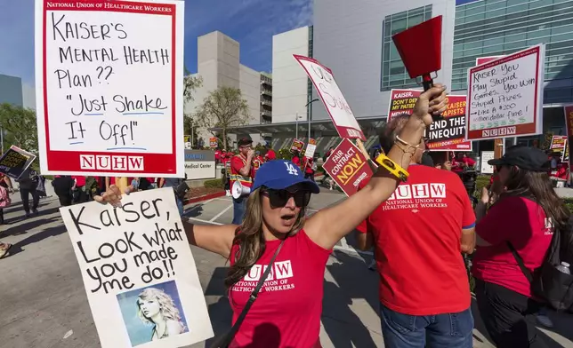 Amy Rocha, a psychiatric social worker, joins mental health workers at outside a Kaiser Permanente building as they begin an open-ended strike in Los Angeles on Monday, Oct. 21, 2024. (AP Photo/Damian Dovarganes)