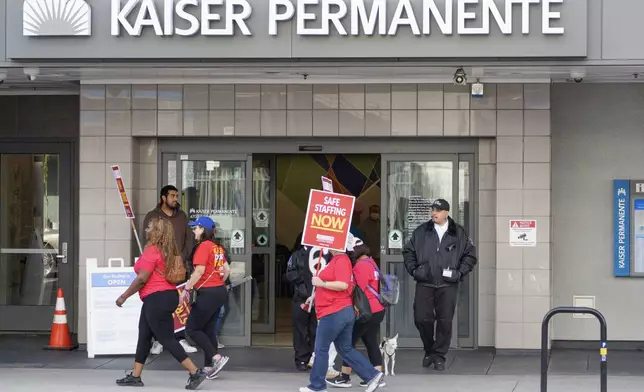 Mental health workers strike outside a Kaiser Permanente facility in Los Angeles Monday, Oct. 21, 2024. (AP Photo/Damian Dovarganes)