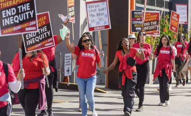 Mental health workers strike outside a Kaiser Permanente facility in Los Angeles Monday, Oct. 21, 2024. (AP Photo/Damian Dovarganes)