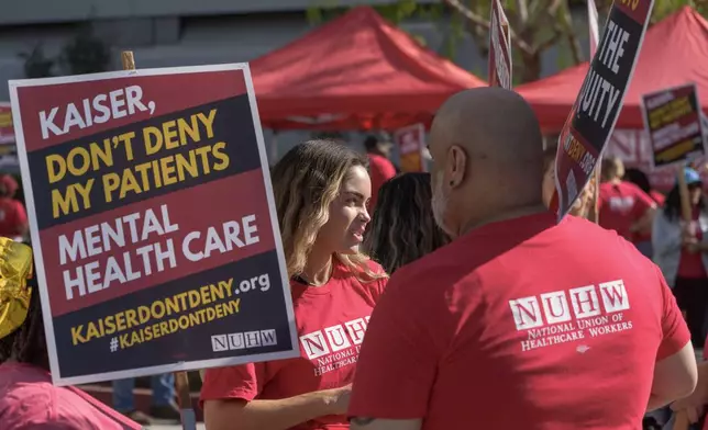 Mental health workers with the National Union of Healthcare Workers (NUHW) outside a Kaiser Permanente facility in Los Angeles Monday, Oct. 21, 2024. (AP Photo/Damian Dovarganes)