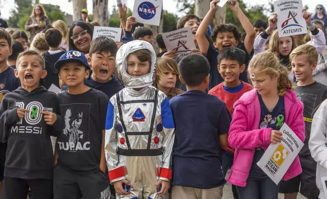 Students at Santiago STEAM Magnet Elementary School participate at a ceremony to plant a small Giant Sequoia tree from NASA's Artemis I Mission's tree seeds that traveled around the moon twice, after the school was honored in the spring of 2024 to become NASA Moon Tree Stewards in Lake Forest, Calif., on Monday, Oct. 14, 2024. (AP Photo/Damian Dovarganes)