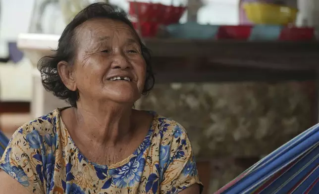 Crocodile farmer Ry Lean, 73, speaks with The Associated Press at her home in Siem Reap province, Cambodia, on Aug. 2, 2024. (AP Photo/Heng Sinith)