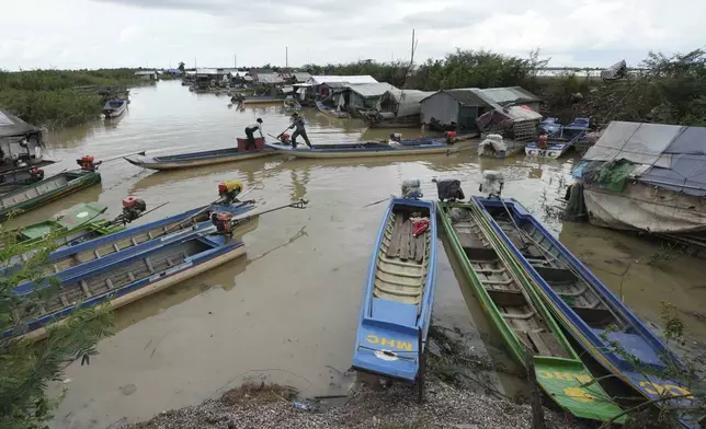 Boats of fisherfolk are anchored by a floating village, by the Tonle Sap in Kampong Chhnang province, Cambodia, Thursday, Aug. 1, 2024, (AP Photo/Heng Sinith)