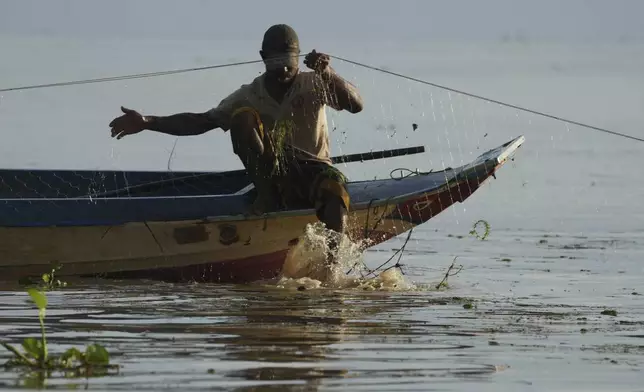 A fisherman fishes in the Tonle Sap in Kampong Chhnang province, Cambodia, Thursday, Aug. 1, 2024, (AP Photo/Heng Sinith)