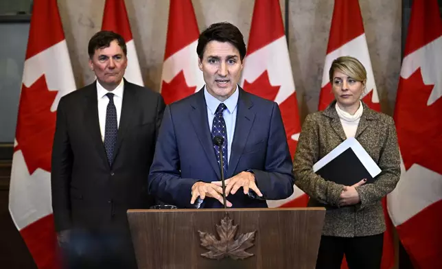 Canadian Prime Minister Justin Trudeau, centre, Minister of Public Safety, Democratic Institutions and Intergovernmental Affairs Dominic LeBlanc, left, and Minister of Foreign Affairs Melanie Joly participate in a news conference on the investigative efforts related to violent criminal activity occurring in Canada with connections to India, on Parliament Hill in Ottawa, Ontario, Monday, Oct. 14, 2024. (Justin Tang/The Canadian Press via AP)