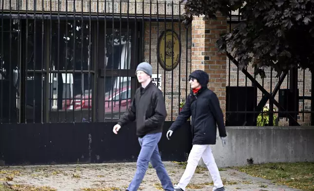 People walk past The High Commission of India in Canada, in Ottawa, Ontario, on Monday, Oct. 14, 2024. (Justin Tang/The Canadian Press via AP)