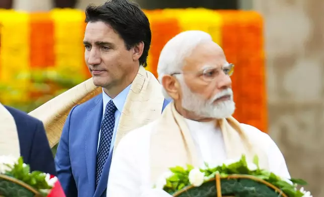 FILE - Canada's Prime Minister Justin Trudeau, left, walks past India's Prime Minister Narendra Modi as they take part in a wreath-laying ceremony at Raj Ghat, Mahatma Gandhi's cremation site, during the G20 Summit in New Delhi, Sept. 10, 2023. (Sean Kilpatrick/The Canadian Press via AP, File)