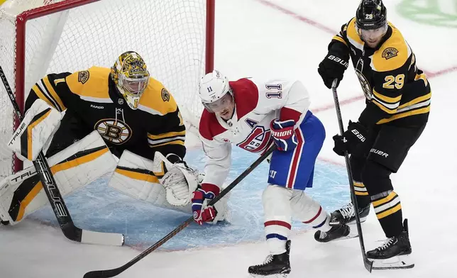 Boston Bruins' Parker Wotherspoon (29) defends against Montreal Canadiens' Brendan Gallagher (11) in front of Jeremy Swayman (1) during the first period of an NHL hockey game, Thursday, Oct. 10, 2024, in Boston. (AP Photo/Michael Dwyer)