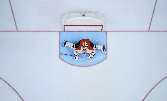 Philadelphia Flyers' Aleksei Kolosov stretches before an NHL hockey game against the Montreal Canadiens, Sunday, Oct. 27, 2024, in Philadelphia. (AP Photo/Matt Slocum)