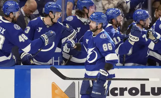 Tampa Bay Lightning right wing Nikita Kucherov (86) celebrates with the bench after his goal against the Vancouver Canucks during the first period of an NHL hockey game Tuesday, Oct. 15, 2024, in Tampa, Fla. (AP Photo/Chris O'Meara)