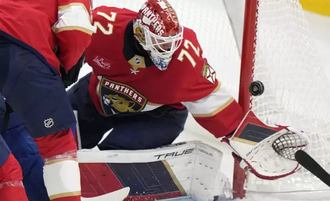 Florida Panthers goaltender Sergei Bobrovsky (72) deflects a shot during the first period of an NHL hockey game against the Vancouver Canucks, Thursday, Oct. 17, 2024, in Sunrise, Fla. (AP Photo/Wilfredo Lee)