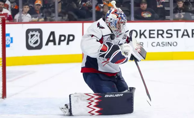 Washington Capitals' Charlie Lindgren with the save during the second period of an NHL hockey game against the Philadelphia Flyers, Tuesday, Oct. 22, 2024, in Philadelphia. (AP Photo/Chris Szagola)