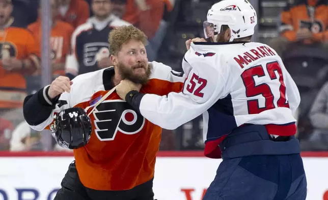 Philadelphia Flyers' Nicolas Deslauriers, left, gets into a fight with Washington Capitals' Dylan McIlrath, during the first period of an NHL hockey game, Tuesday, Oct. 22, 2024, in Philadelphia. (AP Photo/Chris Szagola)