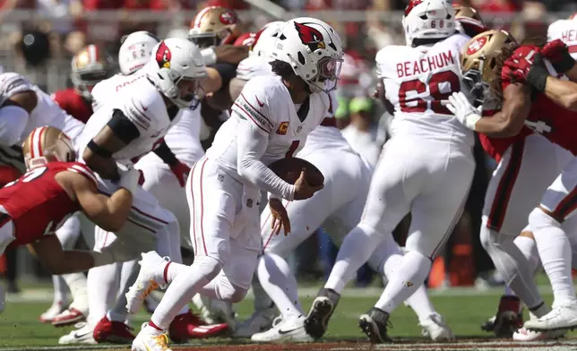 Arizona Cardinals quarterback Kyler Murray, middle, runs for a touchdown during the first half of an NFL football game against the San Francisco 49ers in Santa Clara, Calif., Sunday, Oct. 6, 2024. (AP Photo/Jed Jacobsohn)