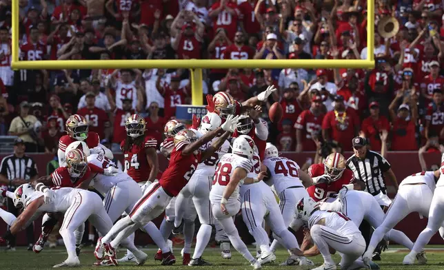 Arizona Cardinals place kicker Chad Ryland, bottom middle, kicks a field goal against the San Francisco 49ers during the second half of an NFL football game in Santa Clara, Calif., Sunday, Oct. 6, 2024. (AP Photo/Jed Jacobsohn)