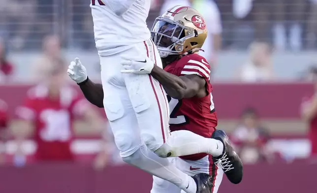 Arizona Cardinals wide receiver Marvin Harrison Jr., top, catches a pass in front of San Francisco 49ers cornerback Isaac Yiadom during the second half of an NFL football game in Santa Clara, Calif., Sunday, Oct. 6, 2024. (AP Photo/Godofredo A. Vásquez)