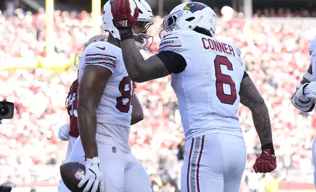 Arizona Cardinals tight end Elijah Higgins, left, is congratulated by running back James Conner (6) after scoring against the San Francisco 49ers during the second half of an NFL football game in Santa Clara, Calif., Sunday, Oct. 6, 2024. (AP Photo/Godofredo A. Vásquez)