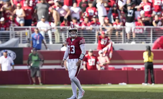 San Francisco 49ers quarterback Brock Purdy (13) walks toward the sideline during the second half of an NFL football game against the Arizona Cardinals in Santa Clara, Calif., Sunday, Oct. 6, 2024. (AP Photo/Godofredo A. Vásquez)