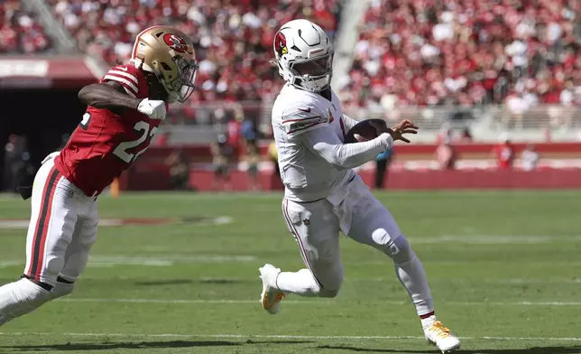 Arizona Cardinals quarterback Kyler Murray, right, runs against San Francisco 49ers cornerback Isaac Yiadom during the first half of an NFL football game in Santa Clara, Calif., Sunday, Oct. 6, 2024. (AP Photo/Jed Jacobsohn)