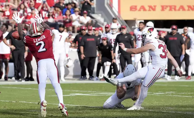 Arizona Cardinals place kicker Chad Ryland, right, kicks a field goal against the San Francisco 49ers during the second half of an NFL football game in Santa Clara, Calif., Sunday, Oct. 6, 2024. (AP Photo/Godofredo A. Vásquez)