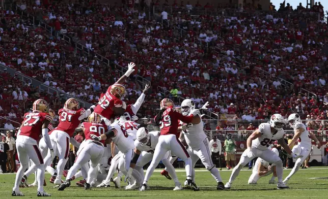 San Francisco 49ers' Jordan Elliott (92) blocks a field goal attempt by Arizona Cardinals place kicker Chad Ryland, right, that 49ers' Deommodore Lenoir returned for a touchdown during the first half of an NFL football game in Santa Clara, Calif., Sunday, Oct. 6, 2024. (AP Photo/Jed Jacobsohn)