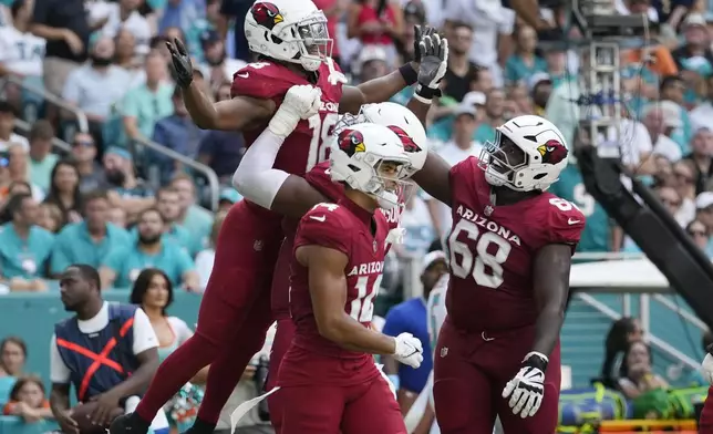 Arizona Cardinals wide receiver Marvin Harrison Jr. (18) celebrates his touchdown during the second half of an NFL football game against the Miami Dolphins, Sunday, Oct. 27, 2024, in Miami Gardens, Fla. (AP Photo/Lynne Sladky)