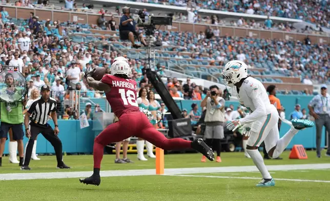 Arizona Cardinals wide receiver Marvin Harrison Jr. (18) grabs a pass for a touchdown during the second half of an NFL football game against the Miami Dolphins, Sunday, Oct. 27, 2024, in Miami Gardens, Fla. (AP Photo/Rebecca Blackwell)