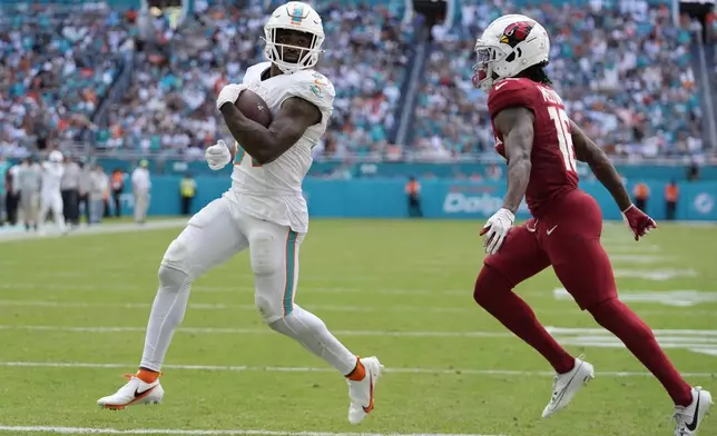 Miami Dolphins running back Raheem Mostert (31) scores a touchdown during the second half of an NFL football game against the Arizona Cardinals, Sunday, Oct. 27, 2024, in Miami Gardens, Fla. (AP Photo/Rebecca Blackwell)