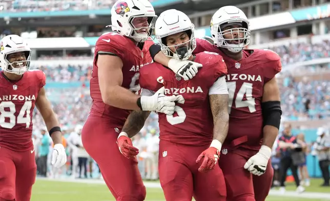 Arizona Cardinals running back James Conner (6) celebrates his touchdown during the second half of an NFL football game against the Miami Dolphins, Sunday, Oct. 27, 2024, in Miami Gardens, Fla. (AP Photo/Rebecca Blackwell)