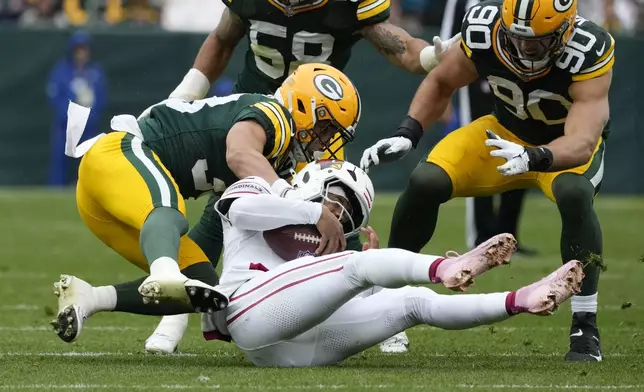 Green Bay Packers safety Evan Williams (33) stops Arizona Cardinals quarterback Kyler Murray during the first half of an NFL football game, Sunday, Oct. 13, 2024, in Green Bay. (AP Photo/Morry Gash)