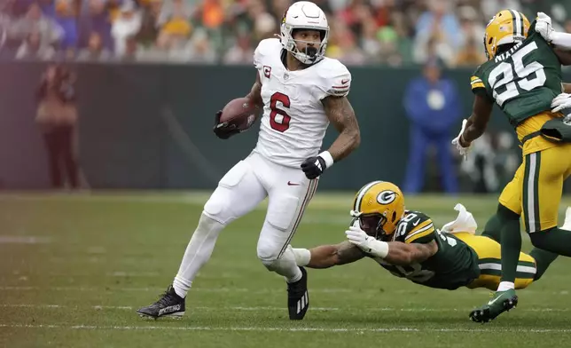 Arizona Cardinals running back James Conner rushes during the first half of an NFL football game against the Green Bay Packers, Sunday, Oct. 13, 2024, in Green Bay. (AP Photo/Matt Ludtke)