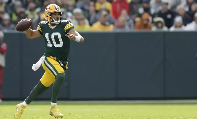 Green Bay Packers quarterback Jordan Love passes during the second half of an NFL football game against the Arizona Cardinals, Sunday, Oct. 13, 2024, in Green Bay. (AP Photo/Matt Ludtke)