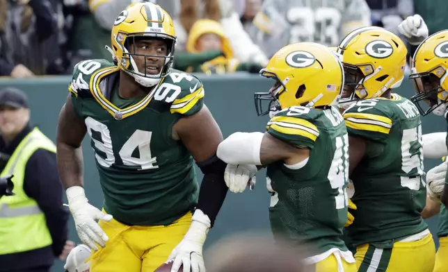 Green Bay Packers defensive end Karl Brooks (94) celebrates after recovering a fumble during the second half of an NFL football game against the Arizona Cardinals, Sunday, Oct. 13, 2024, in Green Bay. (AP Photo/Mike Roemer)