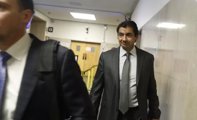 Attorney Tony Brass leaves Department 28 at the Hall of Justice on the first day of the trial of Nima Momeni, a tech consultant charged in the stabbing death of Cash App founder Bob Lee, Monday, Oct. 14, 2024, in San Francisco. (Lea Suzuki/San Francisco Chronicle via AP)