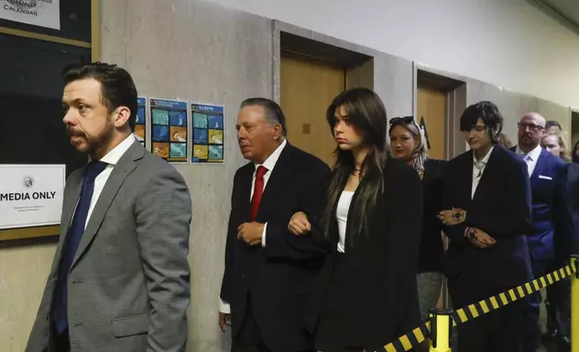 Tim Oliver Lee, left, brother of Cash App founder Bob Lee, Rick Lee, second left, father of Bob Lee; Krista Lee, fourth left, ex-wife of Bob Lee, and other family members of Bob Lee walk to Department 28 to enter the courtroom at the Hall of Justice on the first day of the murder trial of Nima Momeni, Monday, Oct. 14, 2024 in San Francisco. (Lea Suzuki/San Francisco Chronicle via AP)