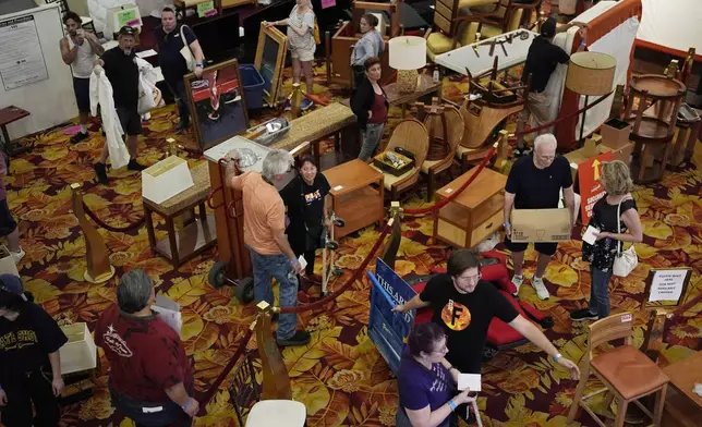 People line up to pay for items during a sale at the shuttered Tropicana hotel-casino Saturday, May 25, 2024, in Las Vegas. (AP Photo/John Locher)