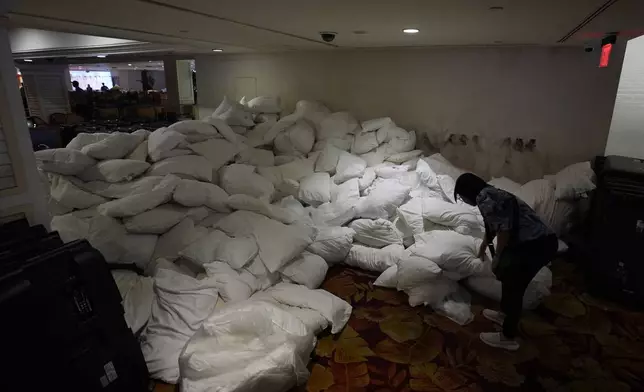 A person looks at a pile of pillows for sale at the shuttered Tropicana hotel-casino Saturday, May 25, 2024, in Las Vegas. (AP Photo/John Locher)