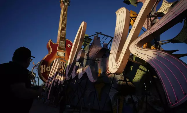 People look at signs from defunct Las Vegas casinos on display at the Neon Museum, Wednesday, April 3, 2024, in Las Vegas. (AP Photo/John Locher)