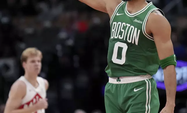 Boston Celtics forward Jayson Tatum (0) reacts to making a 3-point shot during the first half of an NBA preseason basketball game against the Toronto Raptors in Toronto on Tuesday, Oct. 15, 2024. (Nathan Denette/The Canadian Press via AP)