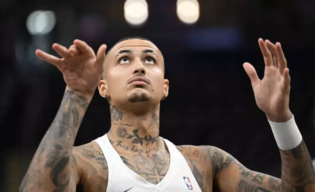 Washington Wizards forward Kyle Kuzma watches his shot during warmups before an NBA basketball game against the Boston Celtics Thursday, Oct. 24, 2024, in Washington. (AP Photo/John McDonnell)