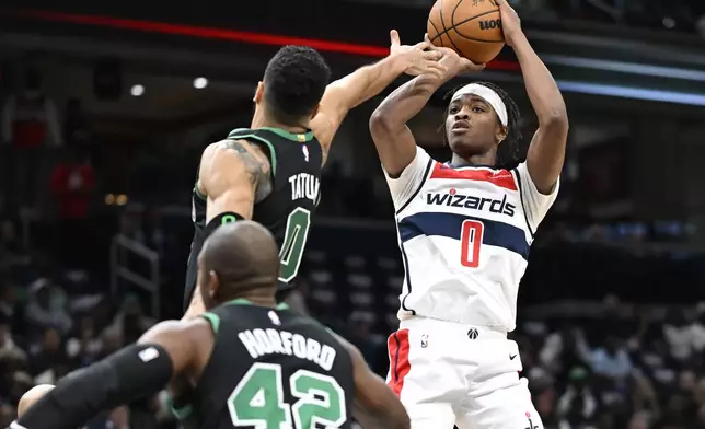 Washington Wizards guard Bilal Coulibaly (0) attempts to shoot against Boston Celtics forward Jayson Tatum, top left, during the first half of an NBA basketball game Thursday, Oct. 24, 2024, in Washington. (AP Photo/John McDonnell)